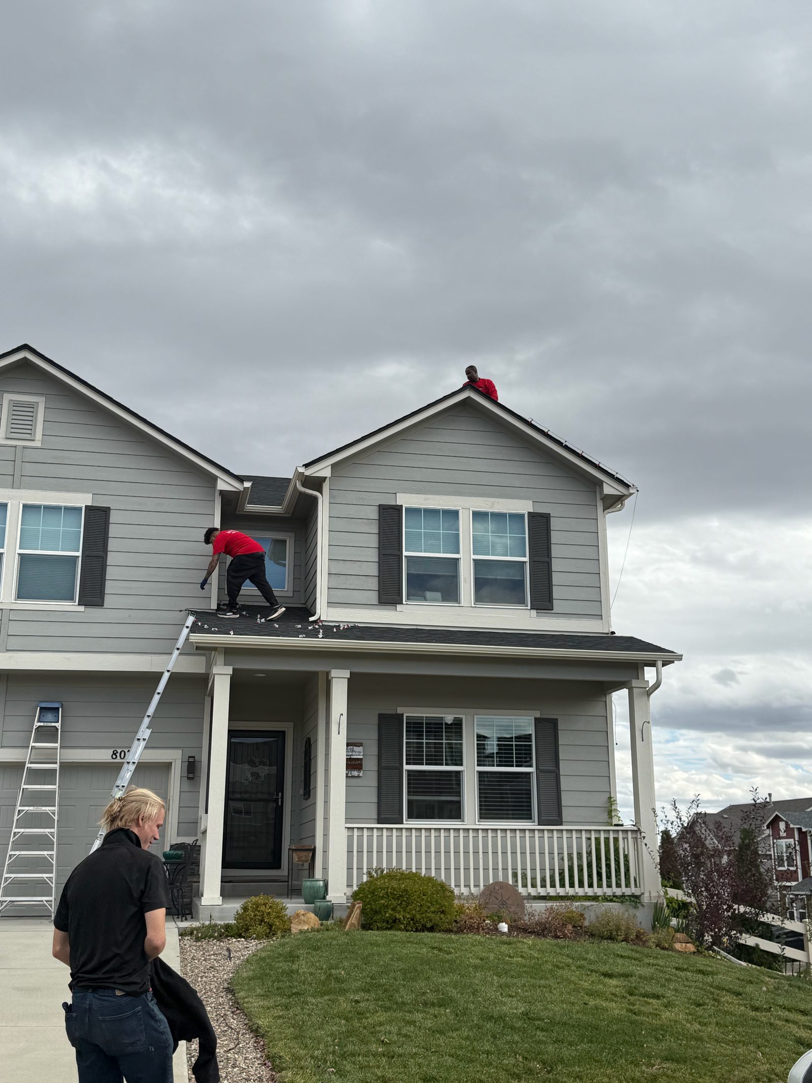 Our crew installing warm white C9 Christmas lights on a two-story home roofline Our crew installing warm white C9 Christmas lights on a two-story home roofline